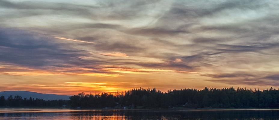 Kayakers enjoying a sunset on Dragon Lake
