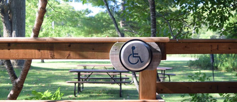 Wooden railing with a wheelchair accessible button